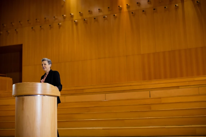Speaker at podium presenting award ceremony